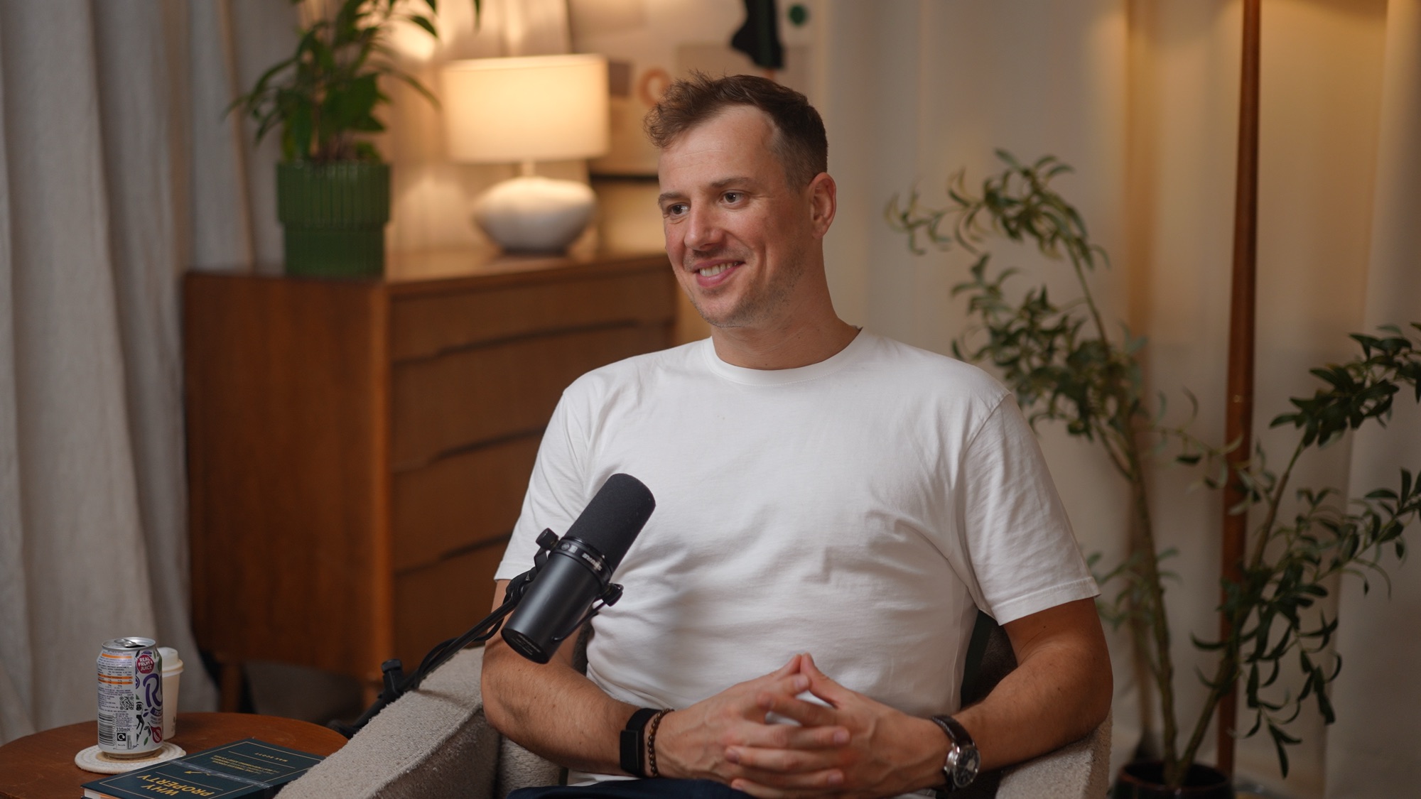 Max Scott, author of Why Property, smiling at a podcast microphone