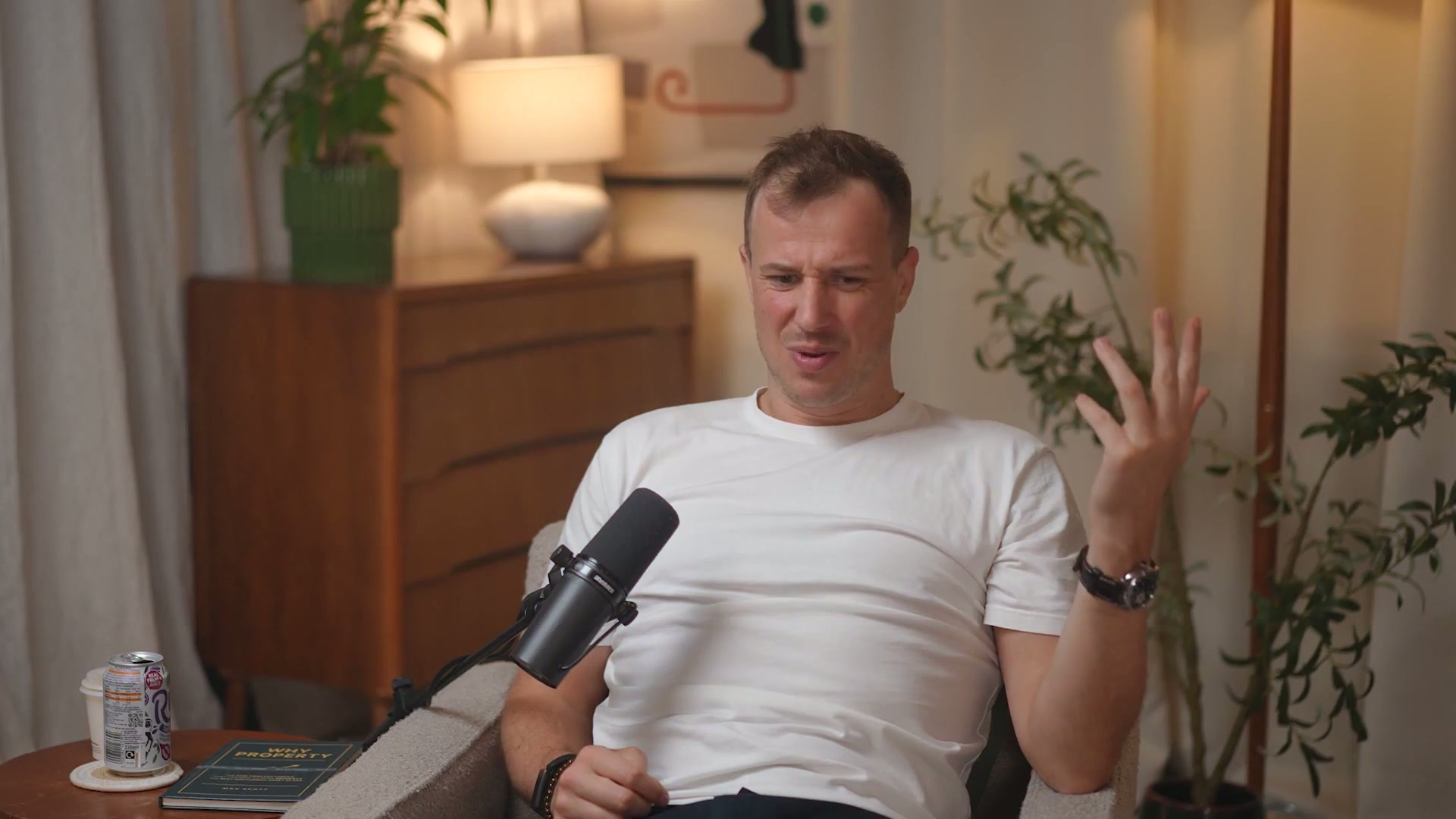 Max Scott in conversation at a podcast microphone